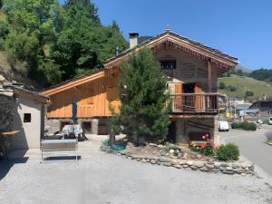 a building with a bench in front of it at Chalet Saint-Roch in Val Cenis +12 photos