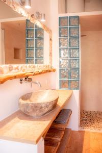 a bathroom with a stone sink on a counter at Casa can Pep Martí in Sant Francesc Xavier +23 photos