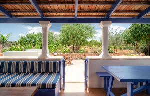 a patio with a blue bench and a table at Casa can Pep Martí in Sant Francesc Xavier