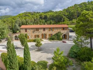 an aerial view of a stone house with a yard at Villa Cava Alta in Riparbella