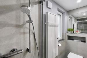a shower with a shower head in a bathroom at Ferienhaus Adelon in Möhnesee