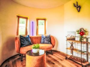a living room with a couch and a table at Chalet Boutique Tiny House by Interhome in Rothenthurm