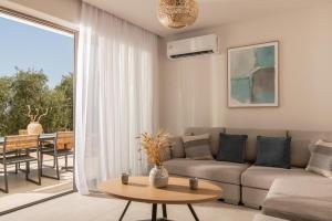 a living room with a couch and a table at Cossoro Cave Villa in Vasilikos