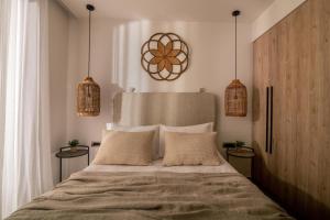 a bedroom with a large bed with two night stands at Cossoro Cave Villa in Vasilikos +8 photos