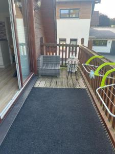 a screened porch with a bench and a rug at Plätzchen am Krebsberg in Simmerath +9 photos