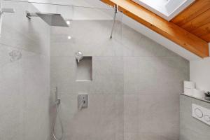 a shower with a glass door in a bathroom at Appartement Monte Fiori in Anzing +19 photos