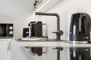 a kitchen counter top with a coffee maker and a coffee pot at Appartement Monte Fiori in Anzing