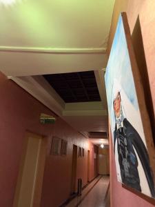 a painting of a man on the wall of a hallway at Hotel Tiznit in Tiznit
