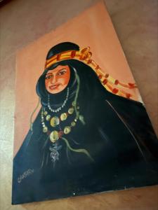 a painting of a woman wearing a necklace at Hotel Tiznit in Tiznit