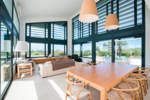a living room with a wooden table and chairs at Villa Forma Nou in Mahón