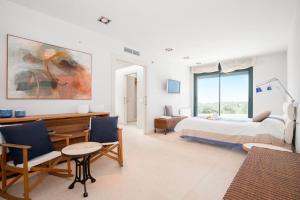 a bedroom with a bed and a table and chairs at Villa Forma Nou in Mahón +37 photos