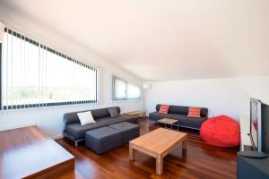 a living room with a couch and a table at Villa Forma Nou in Mahón