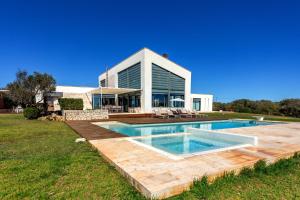 a house with a swimming pool in the yard at Villa Forma Nou in Mahón