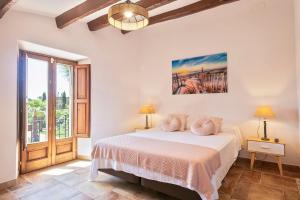a bedroom with a bed and a large window at Masia Luxmarspa in Tordera +32 photos