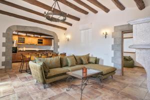 a living room with a couch and a table at Masia Luxmarspa in Tordera