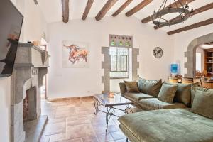 a living room with a couch and a fireplace at Masia Luxmarspa in Tordera