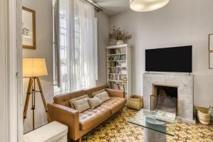 a living room with a couch and a fireplace at Casa señorial 14 personas -C. Brava in Palafrugell