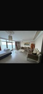 a living room with couches and a chandelier at Trabzon 4 storey Villa-House by the sea - Denize sıfır 4 katlı müstakil Villa - Ev in Trabzon
