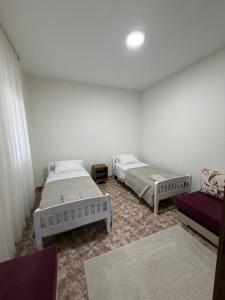 a room with two beds and a couch at Hostel Rinas in Rinas +2 photos