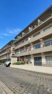 a large apartment building with a car parked in front of it at 01 Tigre Stays in Tigre