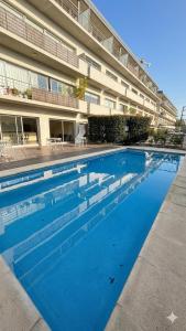 a large swimming pool in front of a building at 01 Tigre Stays in Tigre