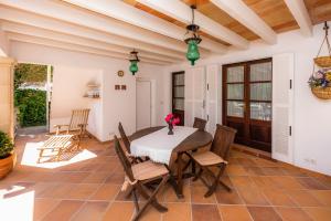a dining room with a table and chairs at Villa Amorós in Cala Ratjada