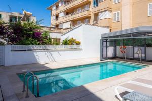 a swimming pool in front of a building at Villa Amorós in Cala Ratjada