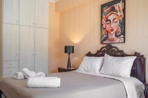 a bedroom with a bed with a painting on the wall at Villa sea view 2 in Athani +17 photos