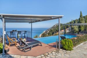 a patio with a view of a pool and the ocean at Villa sea view 2 in Athani