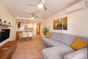 a living room with a couch and a table at Bugalú Playa Paraíso in Adeje