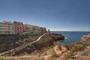 a view of a beach with buildings and the ocean at Bugalú Playa Paraíso in Adeje