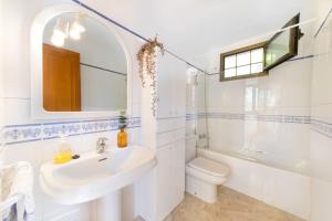 a bathroom with a sink and a toilet and a mirror at S'ancora in Port de Soller +23 photos