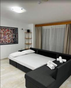 a bedroom with a large bed with two towels at Castle & Sea-Panorama Penthouse in Haraki