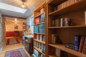 a library with wooden shelves filled with books at O’bord Du Gave in Saucède