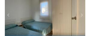a bedroom with two twin beds and a window at Can dennis in Sils +8 photos