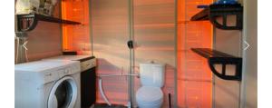 a washing machine in a room with a washing machine at Can dennis in Sils
