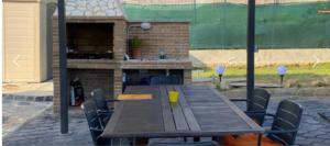 a wooden table and chairs in a patio at Can dennis in Sils
