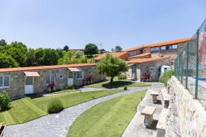 a view of a garden with a stone building at Casa Do Sil in Monforte de Lemos