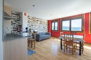 a kitchen and living room with a table and chairs at Casa Do Sil in Monforte de Lemos