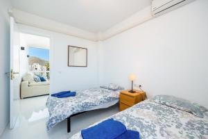 a bedroom with two beds and a mirror at La Plaza in Port de Pollensa +23 photos