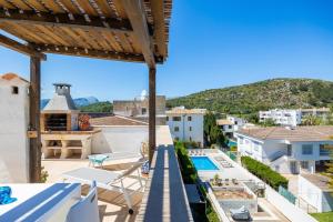 a view from the balcony of a house with a swimming pool at La Plaza in Port de Pollensa