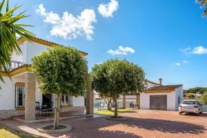 a house with two trees in front of it at Casa García in Cádiz