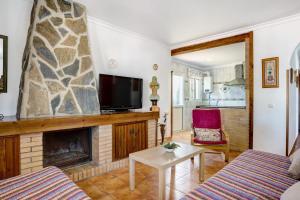 a living room with a fireplace and a tv at Casa García in Cádiz