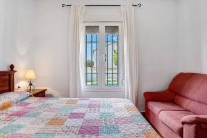 a bedroom with a bed and a couch and a window at Casa García in Cádiz +20 photos