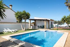 a swimming pool in front of a house at Casa García in Cádiz