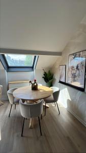 a dining room with a table and chairs at Cloud Stylish flat with jacuzzi near city center in Annecy
