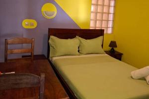 a small bedroom with a bed and a chair at Hôtel Concorde in Antsiranana +18 photos