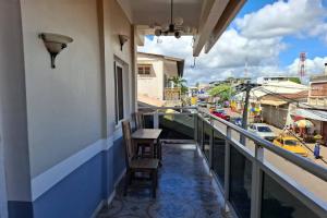 a balcony with a chair and a view of a street at Hôtel Concorde in Antsiranana