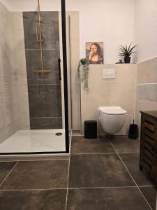 a bathroom with a shower and a toilet at Thiesa in Berumbur +37 photos