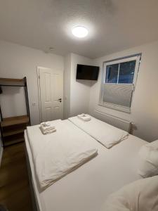 a bedroom with a white bed and a window at Thiesa in Berumbur